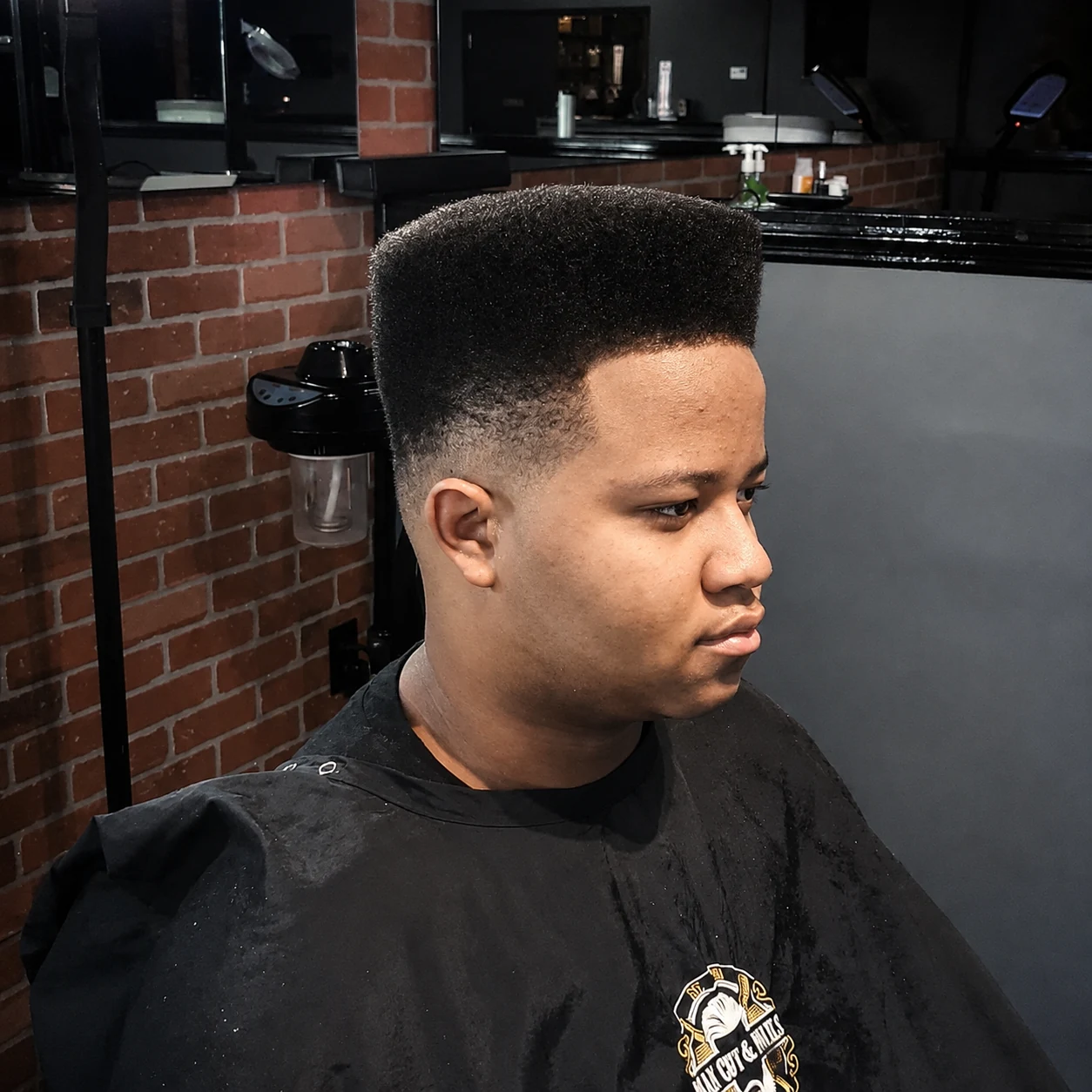 High-top haircut with a sculpted silhouette and faded sides from Ayesha’s portfolio